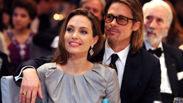epa03181808 (FILE) A file photo dated 13 February 2012 of US actors Angelina Jolie and Brad Pitt attending the charity event &#039;Cinema for Peace&#039; within the scope of the 62nd Berlinale in Berlin, Germany.. British actor Sir Christopher Lee looks on in the background. One of the most eagerly awaited weddings in the history of Hollywood is finally about to happen. Brad Pitt and Angelina Jolie are officially engaged, a spokesman for the couple told People.com on 13 April 2012. Jolie, 36, and Pitt, 48, have been together since 2005, and have six children together: Maddox, 10, Pax, 8, Zahara, 7, Shiloh, 5 and twins Knox and Viv, 3. EPA/PASCAL LE SEGRETAIN / POOL *** Local Caption *** 00000403104907
