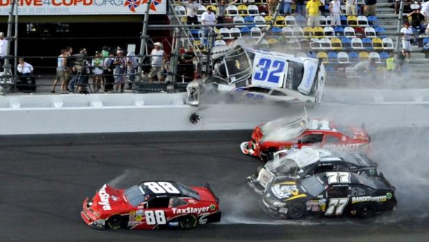 NASCAR driver Kyle Larson (32) and his Chevrolet end up in the fence during the final lap crash during the NASCAR Nationwide Series DRIVE4COPD 300 race at the Daytona International Speedway in Daytona Beach, Florida February 23, 2013. At least 10 cars were involved in a wreck at the Daytona Speedway on Saturday moments before the end of the Nationwide race, in a crash that sent driver Kyle Larson&#039;s car airborne, although he climbed out of the wreckage afterward, ESPN reported. REUTERS/Brian Blanco (UNITED STATES - Tags: SPORT MOTORSPORT TPX IMAGES OF THE DAY)