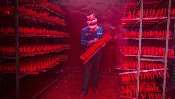 Rote Sterne für Europa: Arbeiter beim Färben der Christbaumschmucks in einer Fabrik in Yiwu