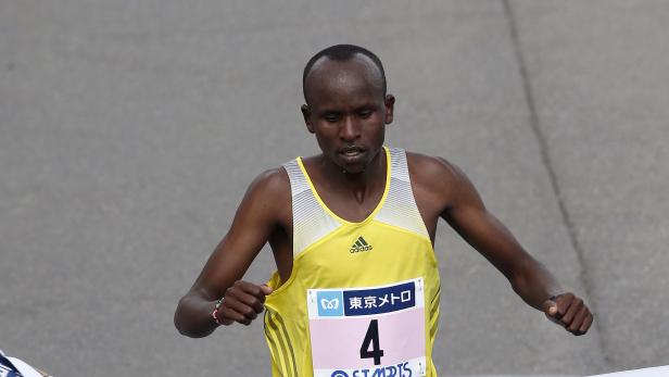 Kitwara of Kenya crosses the finish line to place third in the men's race of the Tokyo Marathon in Tokyo