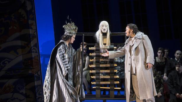 Eine Szene aus einer Opernaufführung mit zwei Darstellern und einer Maske.