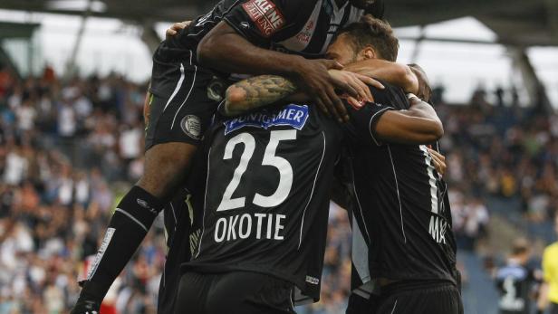 Fußballspieler von SK Sturm Graz feiern gemeinsam ein Tor.