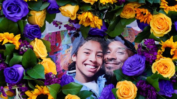 Flowers and photos of Kobe Bryant and his daughter Gianna "Gigi" are placed near the Staples Center to pay tribute after a helicopter crash killed the retired basketball star and his daughter, in Los Angeles