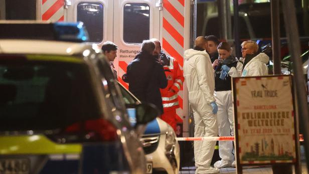Forensic experts are seen outside a shisha bar after a shooting in Hanau near Frankfurt