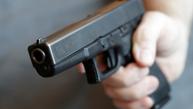 A gun owner displays a Glock 20, 10 mm Auto pistol in Vienna
