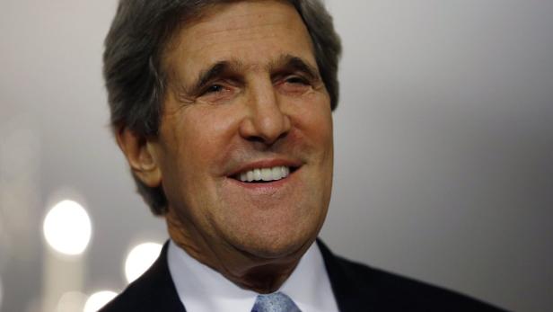 U.S. Secretary of State John Kerry smiles followin