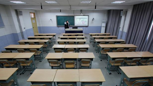 Teacher takes part in a recording of her lessons inside a classroom of a middle school, as students' return to school has been delayed due to the novel coronavirus outbreak, in Shaoyang