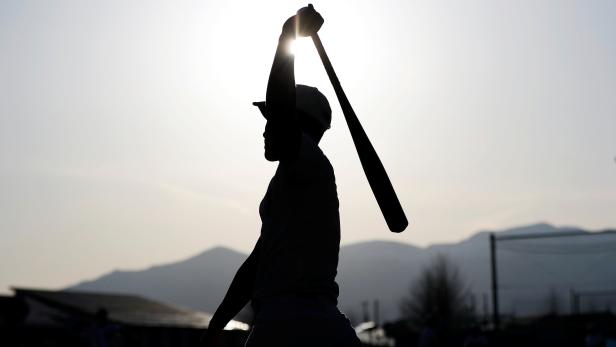 A member of Fukushima Commercial High School baseball team takes part in a workout at the shool's baseball field in Fukushima, Japan