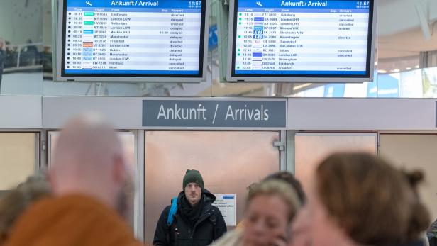 Flughafen-Ankunftstafeln zeigen Flugverspätungen und -ausfälle.
