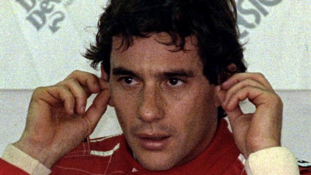 FILE PHOTO: Ayrton Senna of Brazil puts in his earplugs prior to the qualifying session