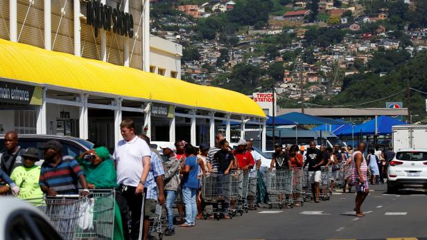 Shoppers queue to stock up on groceries at a Makro Store ahead of a nationwide 21 day lockdown in an attempt to contain the coronavirus disease (COVID-19) outbreak in Durban