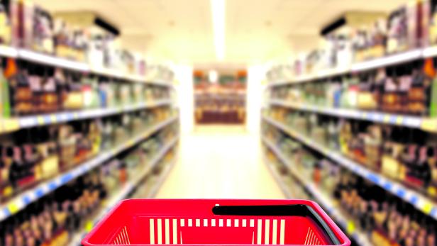 Abstract blurred photo of store with basket in department store bokeh background. business concept.