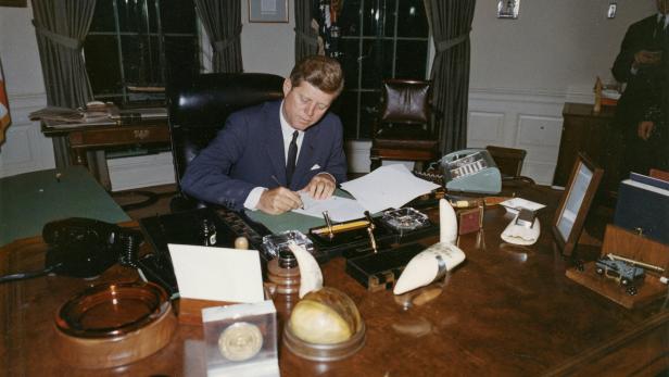 FILE PHOTO: U.S. President Kennedy signs a proclamation at the White House in Washington