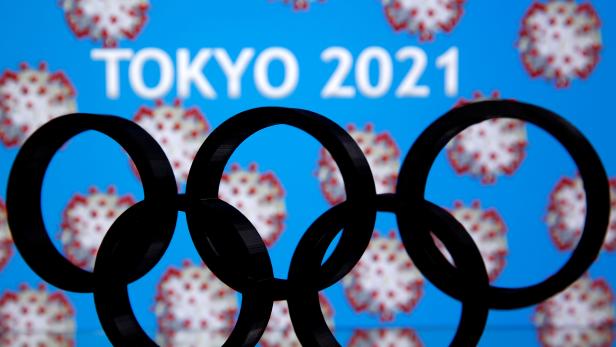 FILE PHOTO: A 3D printed Olympics logo is seen in front of displayed  "Tokyo 2021" words in this illustration