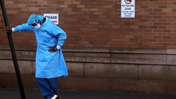 A healthcare worker takes a break outside the emergency center at Maimonides Medical Center during the outbreak of the coronavirus disease (COVID-19) in the Brooklyn, New York