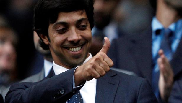 FILE PHOTO: Manchester City's owner Sheikh Mansour bin Zayed Al Nahyan gestures before their English Premier League soccer match against Liverpool at the City of Manchester stadium in Manchester