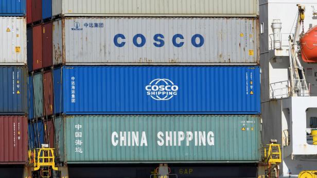 FILE PHOTO: Containers of Chinese companies China Shipping and COSCO (China Ocean Shipping Company) are loaded on a container as it is leaving the port in Hamburg