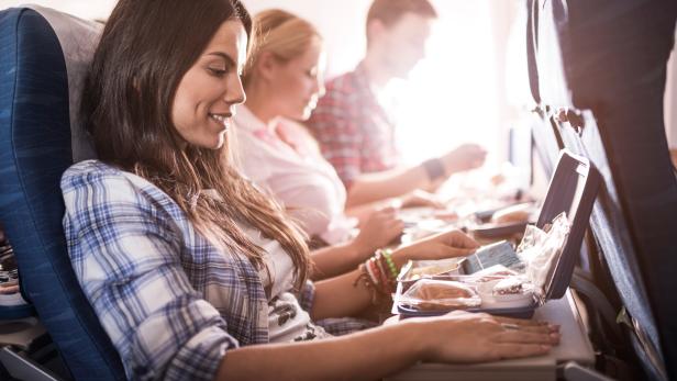 Passengers having lunch while traveling by airplane.