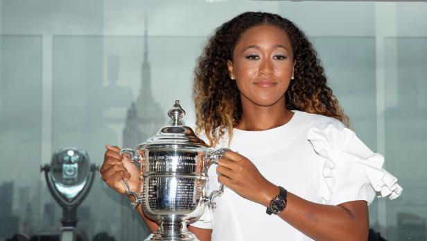 FILE PHOTO: Naomi Osaka of Japan poses with the championship trophy at the Top of the Rock Observatory the day after winning the Women's Singles finals match against Serena Williams at the 2018 U.S. Open