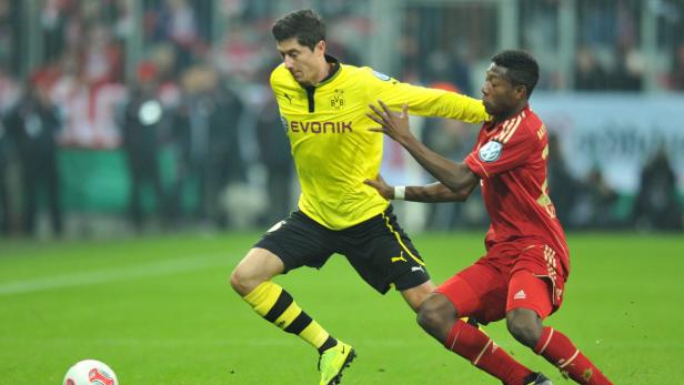 epa03603436 Munich&#039;s David Alaba (R) and Dortmund&#039;s Robert Lewandowski in action during their quarter fnal DFB cup match in Munich, Germany, 27 February 2013. (ATTENTION: The DFB prohibits the utilisation and publication of sequential pictures on the internet and other online media during the match (including half-time). ATTENTION: BLOCKING PERIOD! The DFB permits the further utilisation and publication of the pictures for mobile services (especially MMS) and for DVB-H and DMB only after the end of the match.) EPA/MARC MUELLER