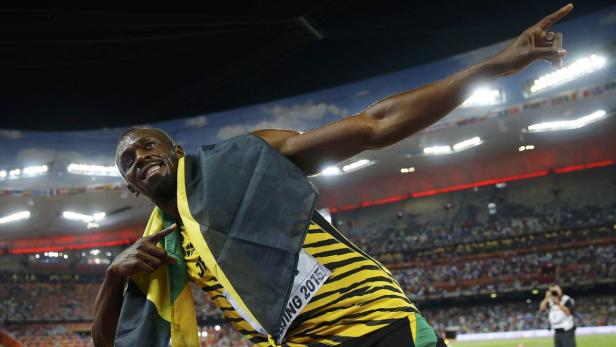 Bolt of Jamaica celebrates after winning the men's