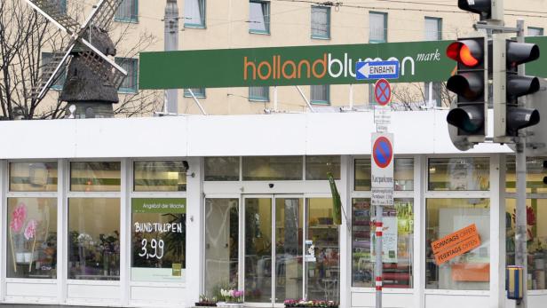 Ein Blumengeschäft „hollandblumark“ mit einer kleinen Windmühle auf dem Dach.