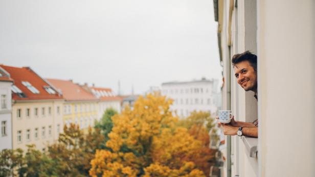 Man looking through the apartment window in Berlin Prenzlauer Berg