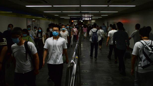 People wearing face masks walk inside a subway station, following the an outbreak of the novel coronavirus disease (COVID-19), in Beijing