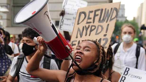 People protest in the street outside a protest to defund the police in a place they are calling the "City Hall Autonomous Zone" in support of "Black Lives Matter" in the Manhattan borough of New York City