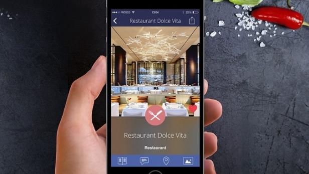 Ein Smartphone zeigt die Inneneinrichtung des Restaurants „Dolce Vita“.