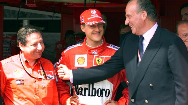 FILE PHOTO:  Spanish King Juan Carlos laughs with German world champion Michael Schumacher and Ferrari team director Jean Todt during a visit to the pits prior to the start of the Spanish Formula One Grand Prix at the Circuit de Catalunya.