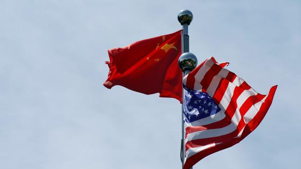FILE PHOTO: Chinese and U.S. flags flutter near The Bund in Shanghai