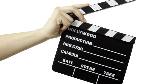 Hollywood Slate board in woman hand isolated