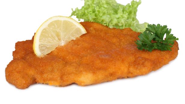 Schnitzel chop cutlet with lemon and lettuce isolated