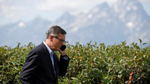 Federal Reserve Vice Chair Richard Clarida talks on the phone during the three-day  "Challenges for Monetary Policy" conference in Jackson Hole
