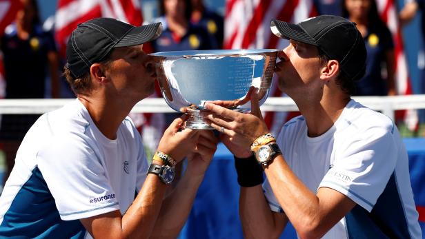 FILE PHOTO: Bob and Mike Bryan kiss their trophy after winning the men's doubles final at the 2014 U.S. Open