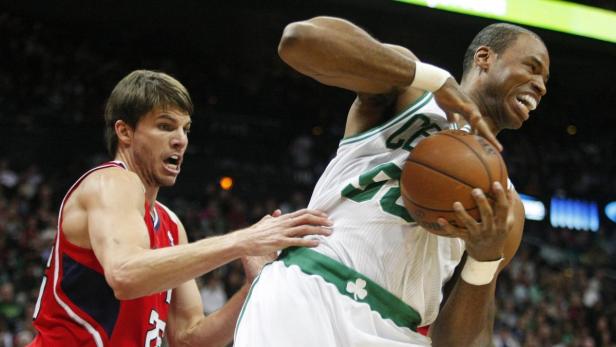 Boston Celtics center Jason Collins (R), grabs a rebound away from Atlanta Hawks guard Kyle Korver in the first half of their NBA basketball game in Atlanta, Georgia January 5, 2013. REUTERS/Tami Chappell (UNITED STATES - Tags: SPORT BASKETBALL)