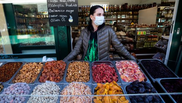 A vendor wearing a protective face mask waits for customers at "Naschmarkt" market amid growing coronavirus disease (COVID-19) in Vienna