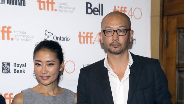 Director Guan Hu and actress Liang Jing arrive on the red carpet for the film "Mr. Six" during the 40th Toronto International Film Festival in Toronto