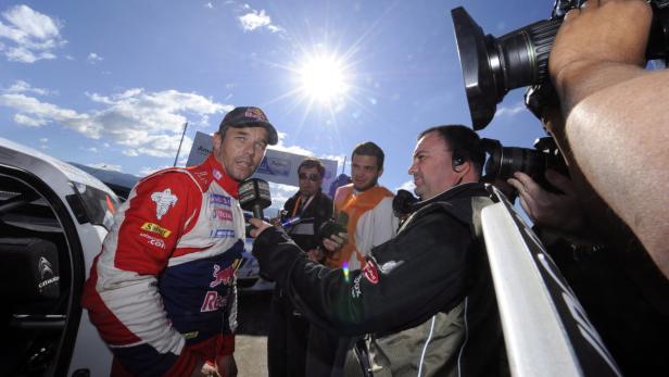 epa03201054 A photo made available 30 April 2012 shows Sebastien Loeb (L) of France talking to the media after winning the Rally of Argentina 2012, Villa Carlos Paz, Argentina, Argentina, 29 April 2012. The Rally of Argentina is the fifth of a total of 13 rallies of the 2012 season for the FIA World Rally Championship, WRC. EPA/REPORTER IMAGES