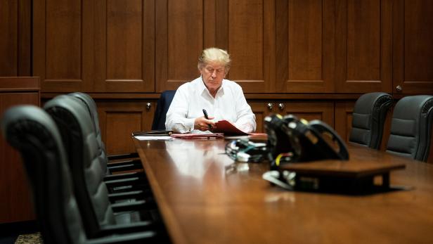 U.S. President Donald Trump works in a conference room while receiving treatment after testing positive for the coronavirus disease (COVID-19) at Walter Reed National Military Medical Center in Bethesda, Maryland