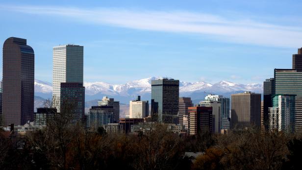 FILE PHOTO: The Continental Divide is seen in the background behind the city skyline in Denver, Colorado