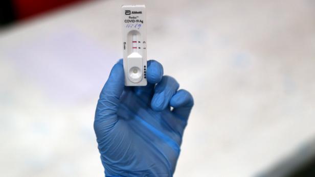 A health worker displays a positive result of coronavirus disease (COVID-19) antigen test in Madrid