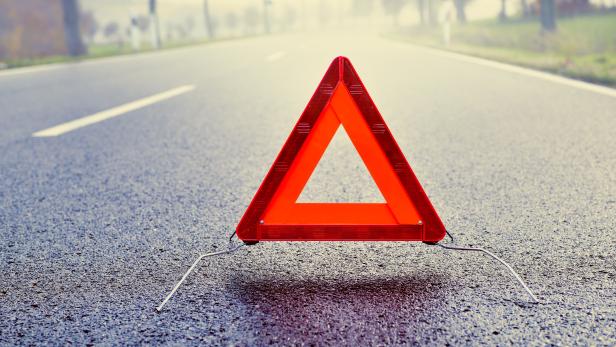 Bad Weather Driving - Warning Triangle on a Misty Road Bad Weather Driving - Warning Triangle on a Misty Road