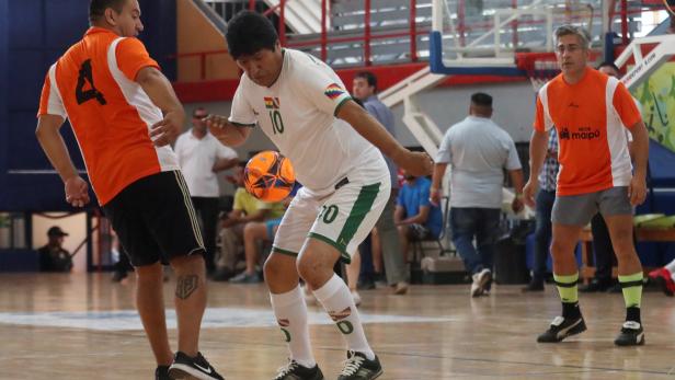 Bolivia's former President Evo Morales drives the ball during a futsal match in Mendoza