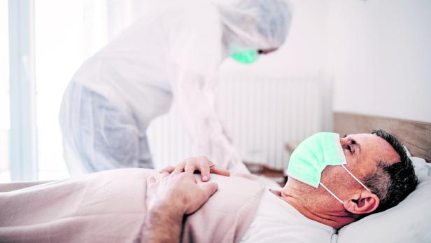 Senior man lying in hospital bed because of coronavirus infection