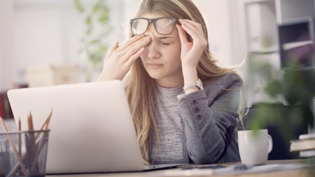 Young tired working woman at work