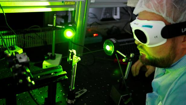A Jenoptik's technician checks a laser unit at a production line of their facility in Jena