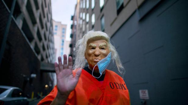 An activist dressed as President Donald Trump wearing a prison jumpsuit in Philadelphia