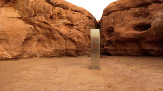A metal monolith is seen in Red Rock Desert, Utah